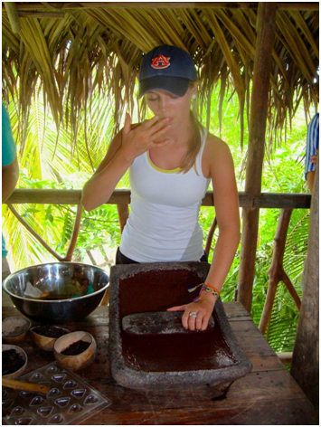 Auburn student preparing a meal in hut in Belize