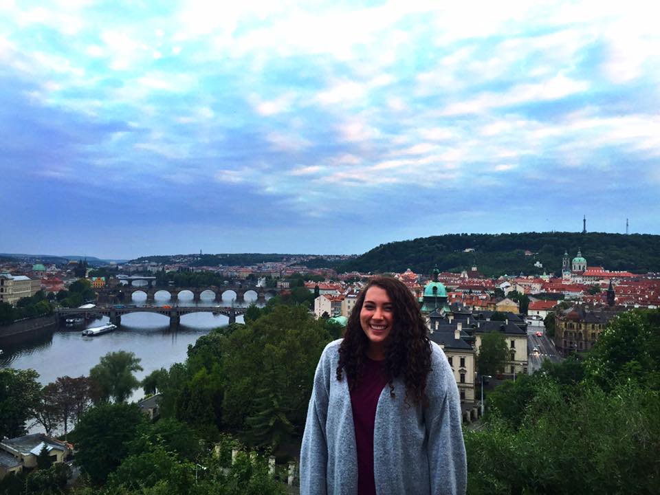 Auburn student pictured abroad in Letna Park with river and arched bridges in background