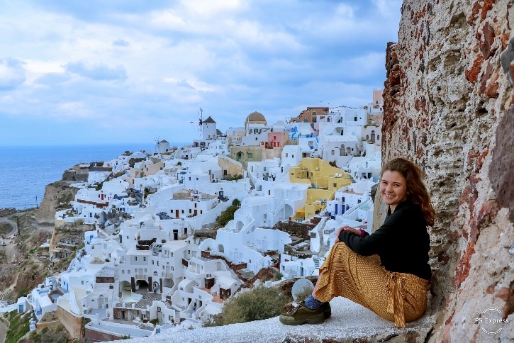 Auburn student pictured abroad overlooking a houses on a cliff